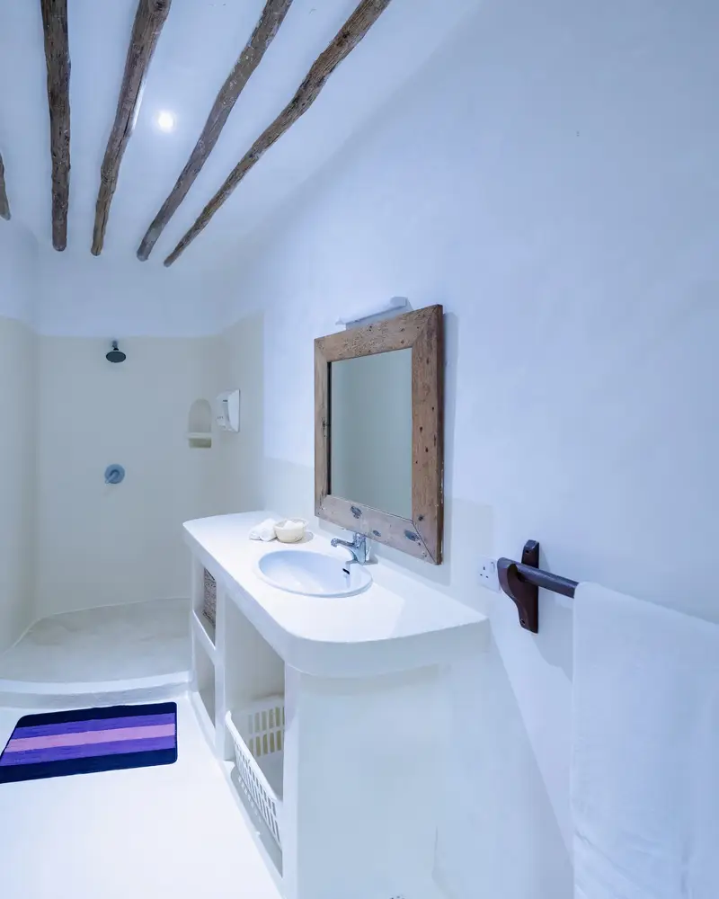 The second bedroom’s ensuite vanity and arched window